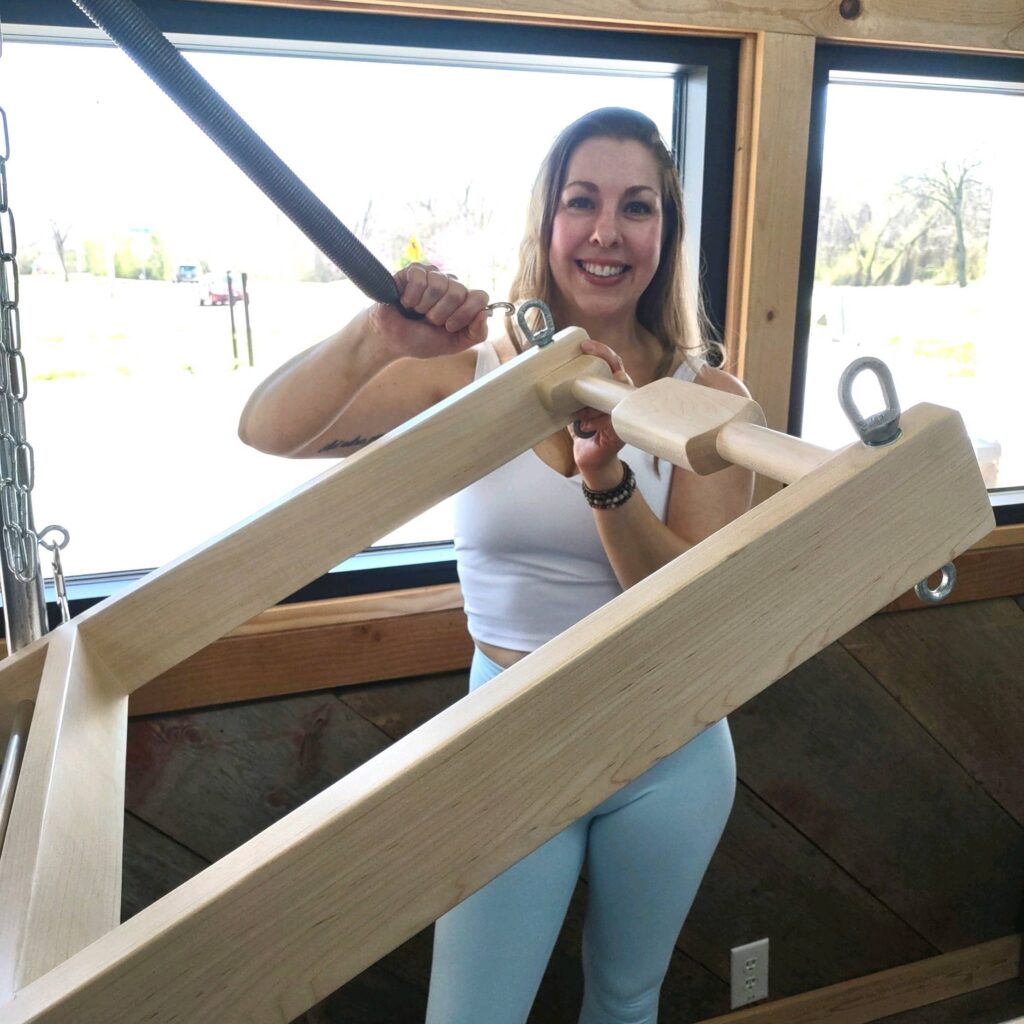 Woman with pilates tower equipment